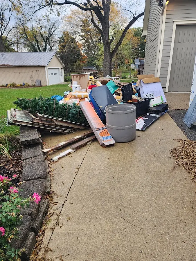 Dumpster being loaded with debris for Estate Cleanout Dumpster Rental in Fort Hunt
